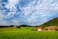 Breathtaking lansdcape of Austrian countryside on sunset. Dramatic sky over idyllic green fields of Anstrian Central Alps on autum