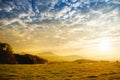 Breathtaking lansdcape of Austrian countryside on sunset. Dramatic sky over idyllic green fields of Anstrian Central Alps on autum