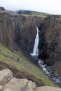 Breathtaking Litlanesfoss waterfall at east of Iceland. Waterfall is framed by basalt columns