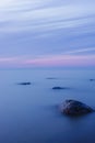 Long exposure seascape on the coast of the Baltic Sea with a smooth purple-blue sky at dusk Royalty Free Stock Photo