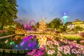 Breathtaking magical landscape in Tivoli Gardens in the evening with lake and flowers. Copenhagen, Denmark. Exotic amazing places Royalty Free Stock Photo