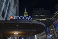 Breathtaking  night view of exterior view of Macy`s sign on wall of store on background from on Empire State Building. Royalty Free Stock Photo
