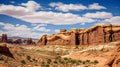 A breathtaking panorama of a canyon with impressive arches and rocks contrasting with a bright sky and clouds