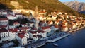 Breathtaking panoramic sunset aerial drone view of the ancient city of Perast, Montenegro. Old medieval little town with red roofs