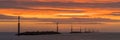 Breathtaking panoramic view of a bright orange sunrise over the horizon of Sea Palling