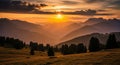 Majestic Mountain Range Silhouetted Against a Fiery Sunset with Golden Light and Dramatic Clouds Royalty Free Stock Photo