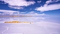 Serene Salt Flat Reflecting a Cloudy Blue Sky Royalty Free Stock Photo