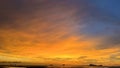 Sunset over a tropical ocean. The sky is a soft blend of orange and pink, and the clouds are wispy and white. Royalty Free Stock Photo