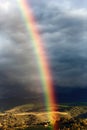 Breathtaking rainbow emerging in beautiful landscape - french pyrenees