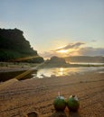 waiting for sunset on the beach with pair of coconut water