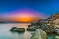 Breathtaking scenery with rock formations near the sea with the reflection of the sunset Royalty Free Stock Photo