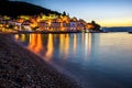 Breathtaking shot of a bay illuminated by buildings at sunrise in Moscenicka Draga, Istria, Croatia