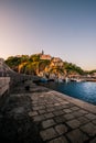 Breathtaking shot of a bay illuminated by buildings at sunrise in Moscenicka Draga, Istria, Croatia