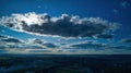 Breathtaking shot of a blue cloudy sky and rural houses on a background