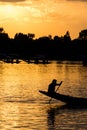 Breathtaking shot of a human silhouette sitting on a boat nose on a beautiful sunset background Royalty Free Stock Photo