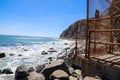 A breathtaking shot of miles of vast deep blue ocean water with waves breaking and crashing in to large rocks in the water Royalty Free Stock Photo