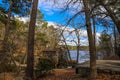 a breathtaking shot of the old wooden grist water mill at Stone Mountain Park with vast blue lake water Royalty Free Stock Photo