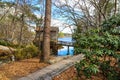 a breathtaking shot of the old wooden grist water mill at Stone Mountain Park with vast blue lake water Royalty Free Stock Photo