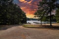 A breathtaking shot of the vast rippling waters of the lake with a long gray and brown wooden dock over the water