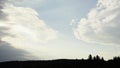 Breathtaking sky with clouds above green forest. Media. Summer landscape with sun rays shining through the clouds. Royalty Free Stock Photo