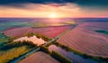 Breathtaking summer sunrise on Ternopil outskirts with smal lake and asphalt road. Royalty Free Stock Photo