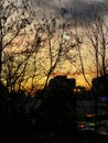 Breathtaking sundown in Bucharest seen through the balcony window glass