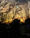 Breathtaking sundown in Bucharest seen through the balcony window glass