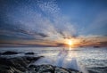 Breathtaking sunrise at the beach reflecting in the sea in Lofoten, Norway