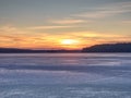 Breathtaking sunset with blue pink clouds over frozen lake Royalty Free Stock Photo