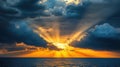 God Rays Break Through Clouds Over Sea at Sunset Royalty Free Stock Photo