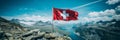Breathtaking swiss mountain landscape with the flag of switzerland fluttering in the wind