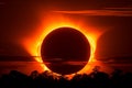 Breathtaking total solar eclipse with dramatic sky and sunburst illuminating the horizon Royalty Free Stock Photo