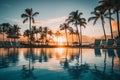 Breathtaking tropical oasis infinity pool, palm trees, and sunset at stunning beach resort Royalty Free Stock Photo