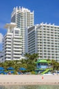 Breathtaking view from Atlantic Ocean of white sandy beach with sun loungers, sun umbrellas, and coastal buildings in background. Royalty Free Stock Photo