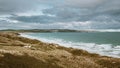 Breathtaking view of the beach and the sea under the cloudy sky captured in Cornwall, England Royalty Free Stock Photo