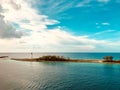 Bahamian lighthouse welcomes guests to the beautiful blue harbour Royalty Free Stock Photo