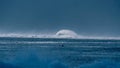 Breathtaking view of a distant turquoise wave approaching the coast of Tahiti.