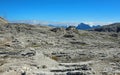 Breathtaking view of the European Alps mountains with a moonscape-like and mountain refuge nestled among the rocks