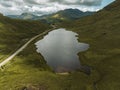 Breathtaking view of green Scottish highlands with a cloudy sky