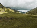 Breathtaking view of green Scottish highlands with a cloudy sky