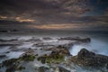 Breathtaking view of Karang Bokor Sawarna in Indonesia under dark cloudy sunset sky, long exposure