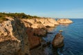Breathtaking view of the limestone rocks with arches and small secluded beach. Algarve, Portugal Royalty Free Stock Photo