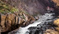 Breathtaking view of a majestic waterfall cascading through a rocky river bed Royalty Free Stock Photo