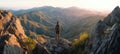 The breathtaking view from a mountaintop during sunset with a lone hiker. AI generated image Royalty Free Stock Photo
