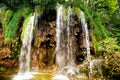 Breathtaking view of natural waterfall, lake cascade and water in deep tropical forest.