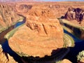 Breathtaking view of a red rock desert and a water stream surrounding the rocks Royalty Free Stock Photo