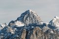 Breathtaking view of the rocky peak of Mount Mangart covered in snow in the Julian alps in Slovenia