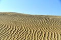 Breathtaking view of sand dunes ripples of Al Qudra desert and a clear blue sky Royalty Free Stock Photo