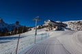 Breathtaking view of a snow-capped mountain in the Dolomites, with a chairlift. The majestic peaks loom in the distance, blanketed