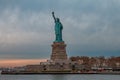 Breathtaking view of the Statue of Liberty against the dark cloudy sky Royalty Free Stock Photo